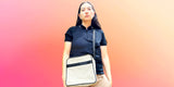 House of JX sustainable accessories square crossbody bag. Cream leather with black stripe and black strap.