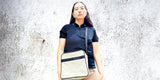 House of JX sustainable accessories square crossbody bag. Cream leather with black stripe and black strap.