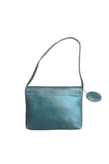 Back view: Flap close small handbag, caramel finish leather, vivid teal color with seafoam lining and stitches. Upcycled, sustainable.