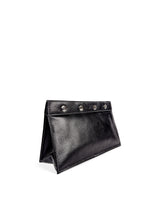 Subtle pebbled black leather toiletry bag with white accent stitches, 4 large silver snaps closure. Black nylon lining. 2 interior slip pockets and main compartment. Upcycled, circular, sustainable. 3/4 view.