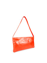 Small slim vivid orange leather handbag. Playful pale orange satin lining and contrast stitch accent. Sunken zipper closure. 3/4 view. Upcycled, circular, sustainable.