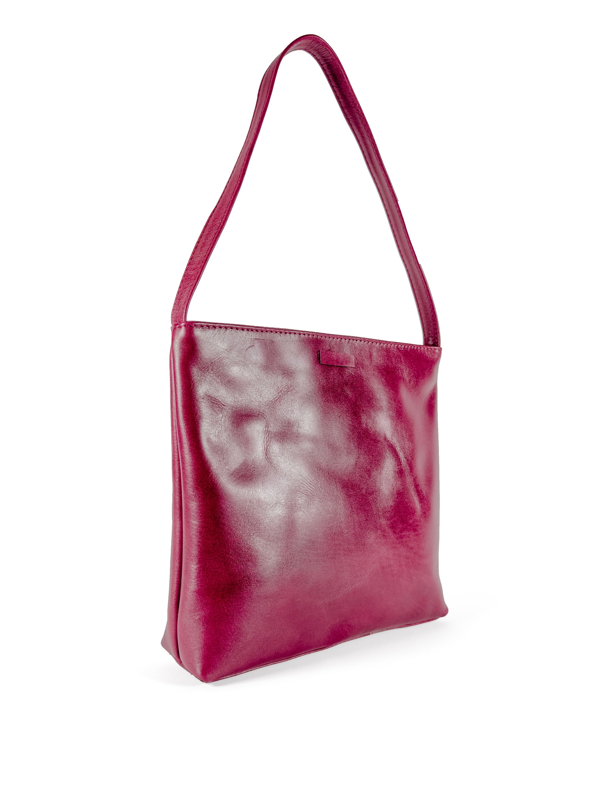 Medium polished burgundy leather handbag. Elegant muted pink satin lining. Sunken zipper closure. 3/4 view 2. Upcycled, circular, sustainable.
