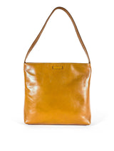 Medium polished tan leather handbag. Elegant muted lemon satin lining. Zipper closure. Front view. Upcycled, circular, sustainable.