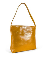 3/4 view 1 of a medium polished tan leather handbag. Elegant muted lemon satin lining. Zipper closure. Front view. Upcycled, circular, sustainable.