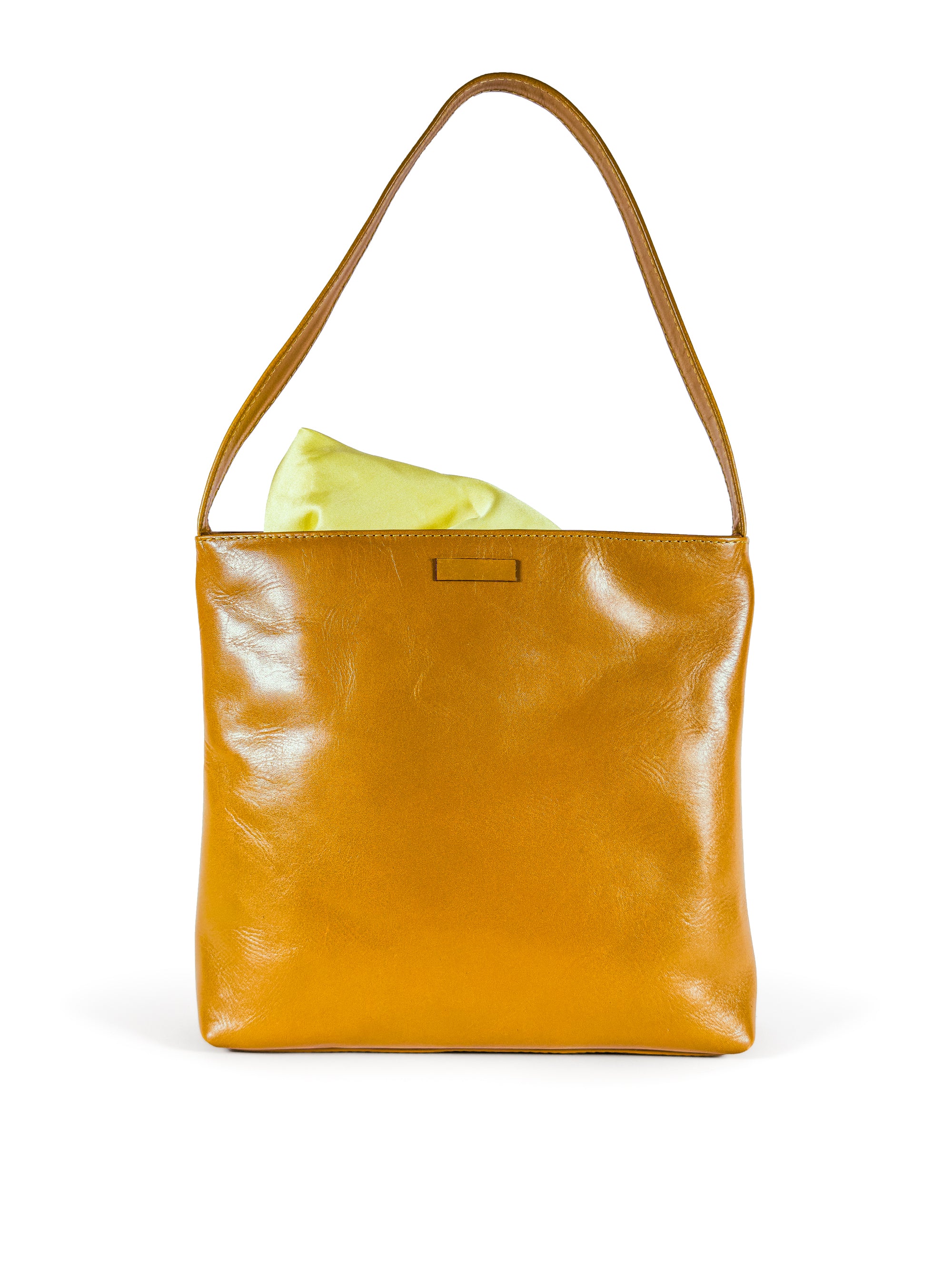 Medium polished tan leather handbag. Elegant muted lemon satin lining. Zipper closure. Front view with lining showing. Upcycled, circular, sustainable.