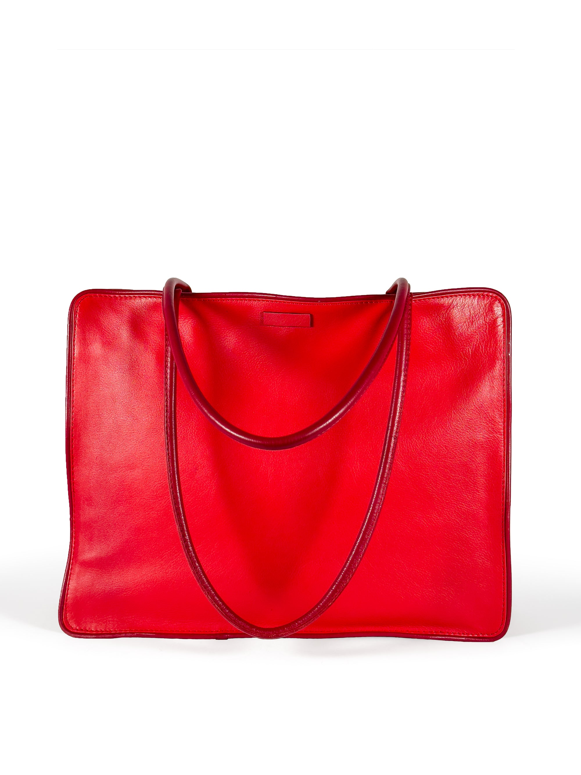 Large vivid red leather tote bag with deep red piping, xl pipe shoulder straps, lining and contrast stitches.Front view 1. Upcycled, circular, sustainable.
