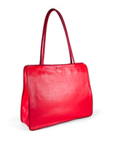 Large vivid red leather tote bag with deep red piping, xl pipe shoulder straps, lining and contrast stitches. Side panel hidden magnet expansion to 4 inches depth. 3/4 view 1. Upcycled, circular, sustainable.