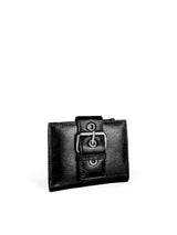 Small Wallet. Buttery pebbled black leather with nickel hardware. 1 magnet closure hidden under wide strap with buckle. 3/4 view. Upcycled, circular, sustainable.