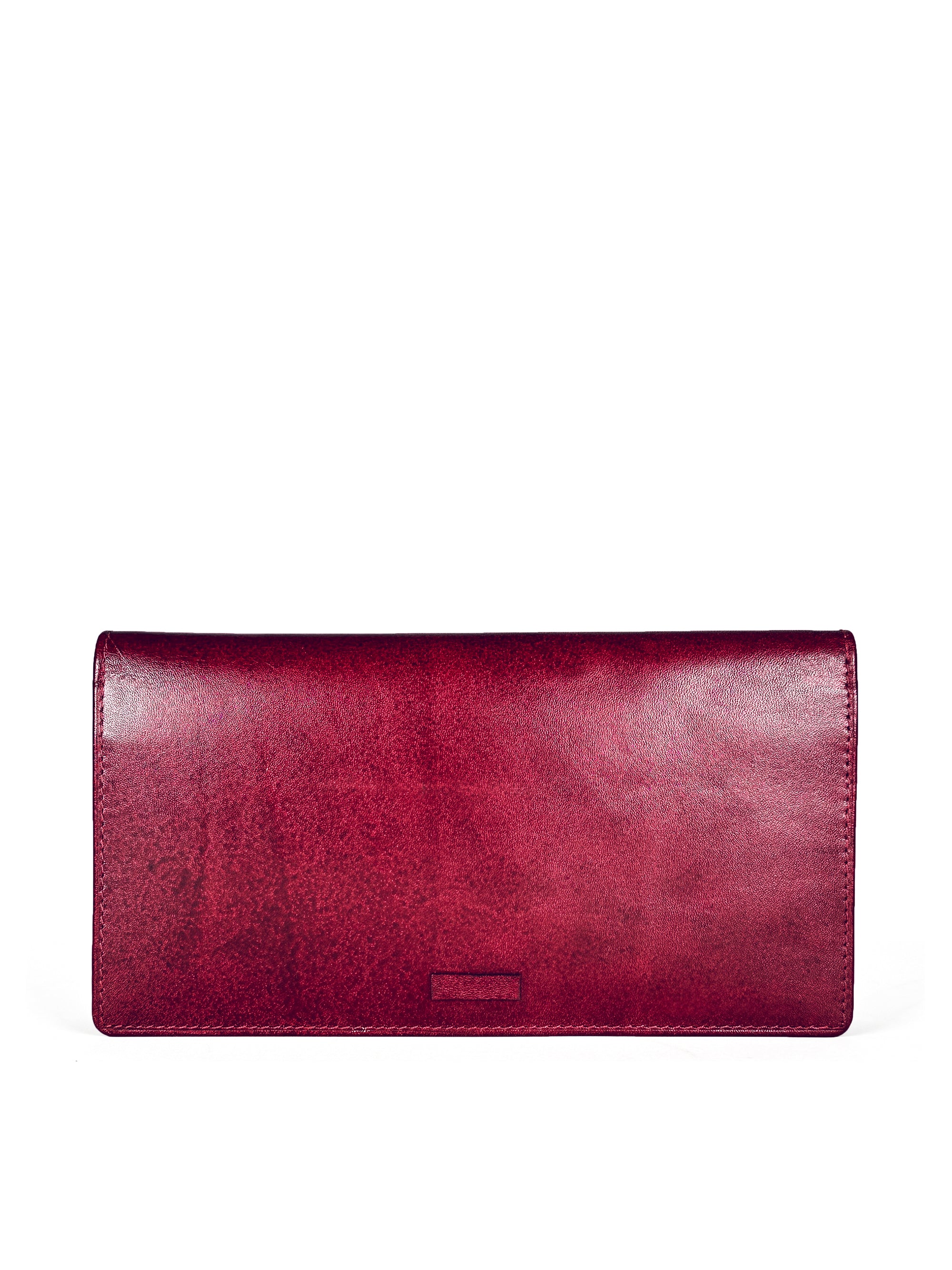 Long slim folding wallet in polished burgundy leather. Elegant muted pink satin lining. Hidden snap closure. Interior view. 8 card slots, three full length bill sleeves. Interior zip closure coin compartment. Upcycled, circular, sustainable. Front view.