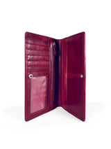 Long slim folding wallet in polished burgundy leather. Elegant muted pink satin lining. Hidden snap closure. Interior view. 8 card slots, three full length bill sleeves. Interior zip closure coin compartment. Upcycled, circular, sustainable. Interior view.