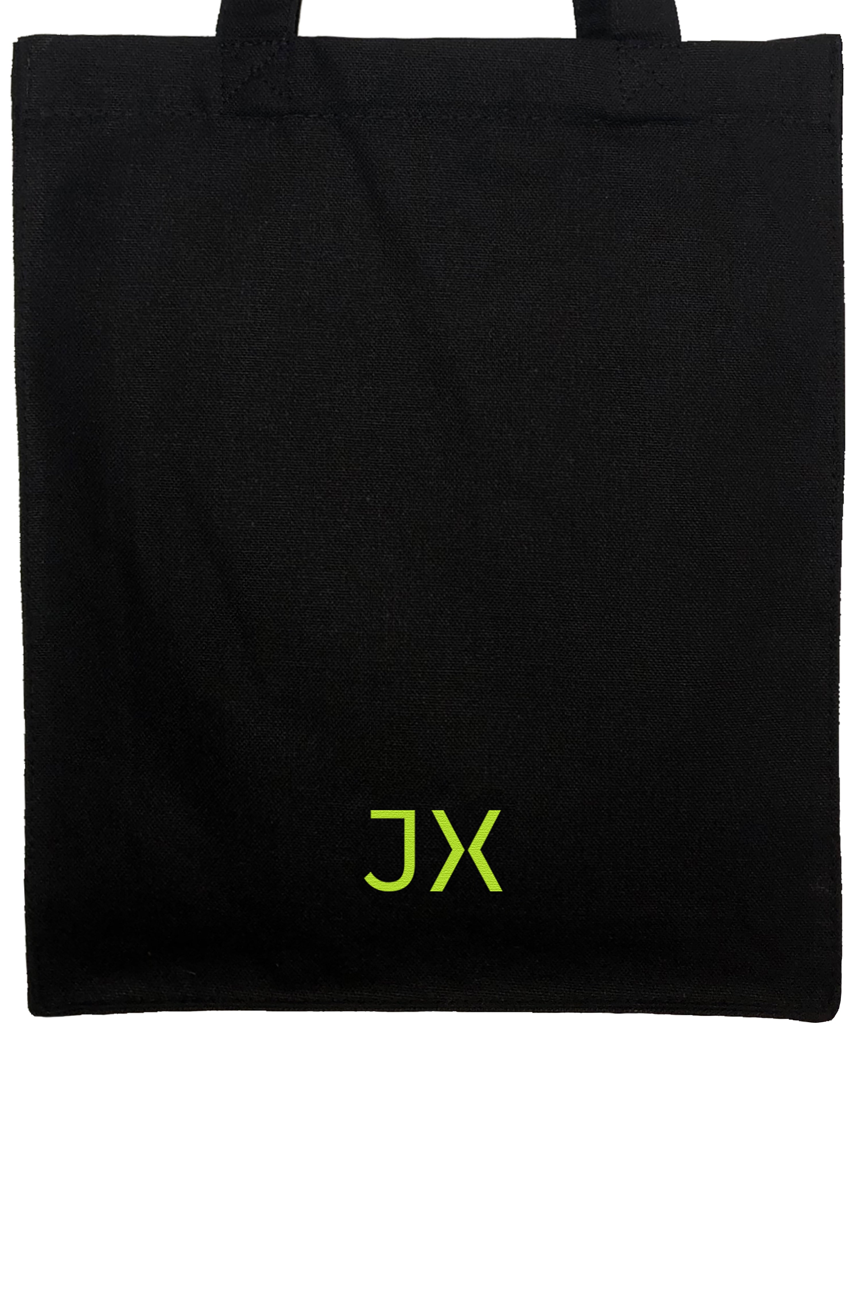 Small slim organic heavyweight canvas tote in black. Neon JX logo accent. Detail view. Sustainable.