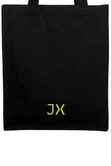 Small slim organic heavyweight canvas tote in black. Neon JX logo accent. Detail view. Sustainable.