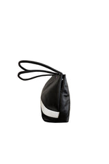 Black leather medium sized handbag, with tapered top. Inlaid white leather accent stripe on front panel. Magnet depth expansion. Chic padded pipe shoulder straps. Upcycled, circular, sustainable. Side view.