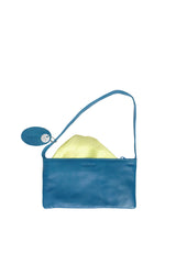 Small slim blue leather handbag. Elegant pale yellow satin lining and contrast stitch accent. Sunken zipper closure. Lining view. Upcycled, circular, sustainable.