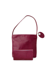 Accessories bundle deal. Medium polished burgundy leather handbag. Elegant muted pink satin lining. Zipper closure. Matching slim long folding wallet with hidden snap closure. Upcycled, circular, sustainable.