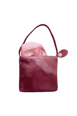 Medium polished burgundy leather handbag. Elegant muted pink satin lining. Zipper closure. Lining view. Upcycled, circular, sustainable.