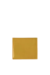 Polished tan leather mini wallet. Elegant muted lemon satin lining. Upcycled, circular, sustainable. Front view.