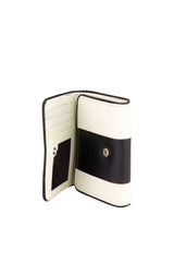 Medium sized wallet. Cream colored leather with inlaid thick black leather stripe. Black leather piping. Flap close & hidden snap. Upcycled, circular, sustainable. Interior view.