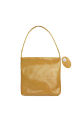 Medium polished tan leather handbag. Elegant muted lemon satin lining. Zipper closure. Front view. Upcycled, circular, sustainable.