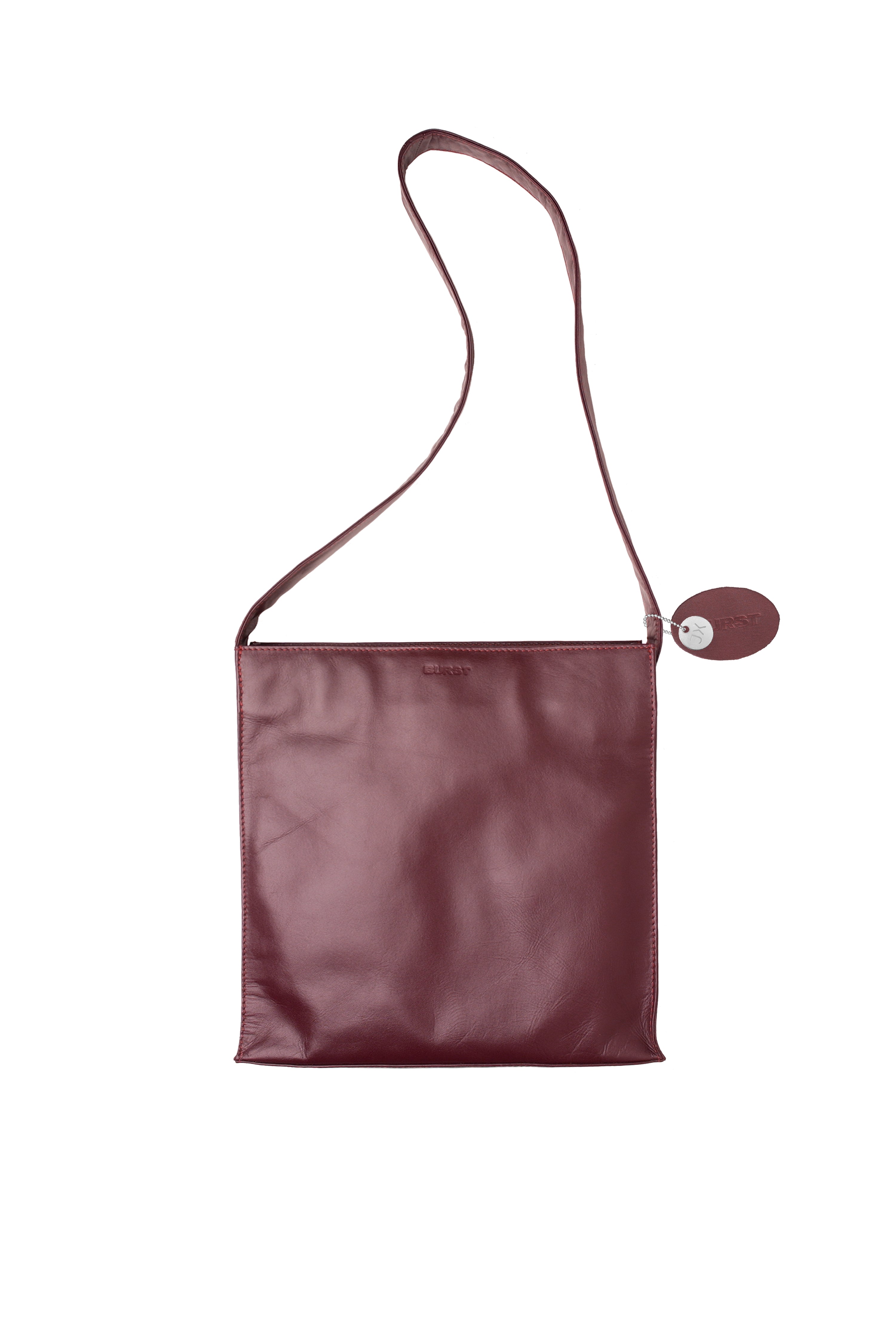 Caramel finished leather large cross body bag. Chic wide strap. Deep raspberry red toned brown with vivid Pink Grapefruit lining and stitch.
